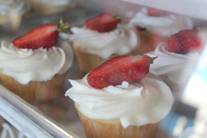 close up of cupcakes in a display case