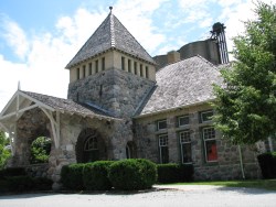 Stone train station with grain silos behind