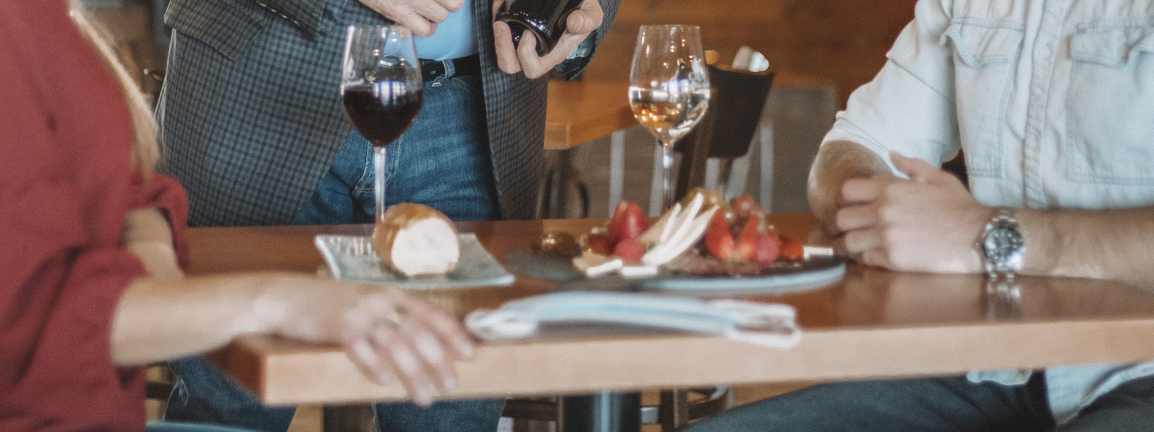 close up of a couple eating pizza and drinking wine
