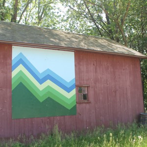 closeup of a barn with a colourful piece of artwork on the side